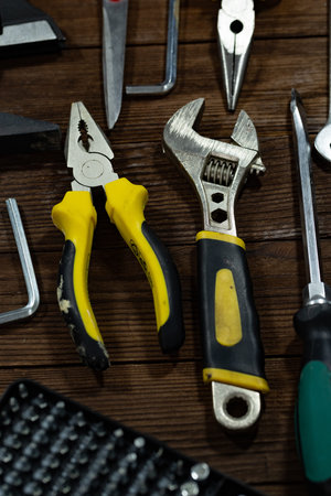 Set of tools on a wooden background. Pliers, pliers, screwdrivers, wrenches.