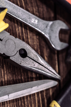 Tools for repair on a wooden background. Selective focus. Shallow depth of field. Toned.