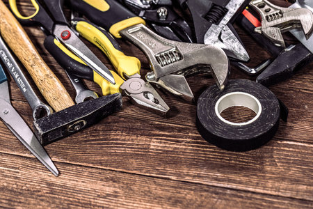 Variety of tools on vintage wooden board. Top view with copy space