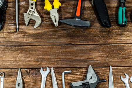 Variety of tools on wooden background. Top view. Copy space.