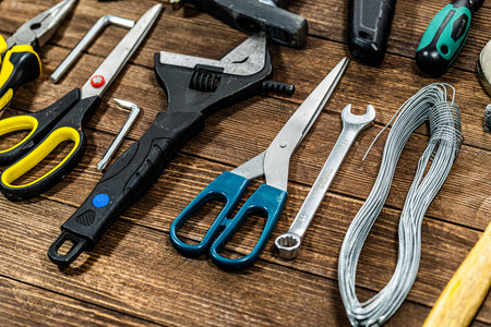 Variety of construction tools on wooden background. Top view. Copy space.