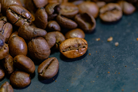 Coffee beans on a black background. Selective focus.