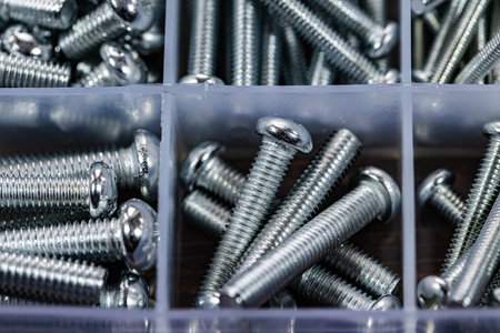 Close up of a set of screws in a box. Selective focus.