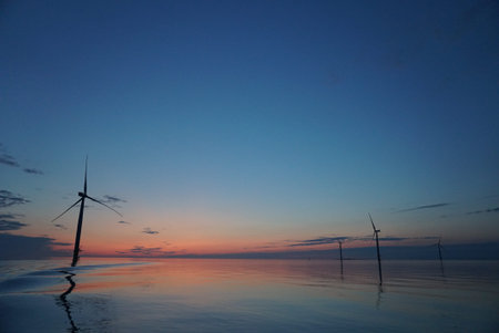 Baltic sea with an offshore wind farm at night time with calm waters