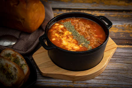 tomato soup served with garlic breadの写真素材
