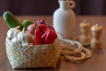 Basket with fresh vegetables on a wooden table. Selective focus.の写真素材