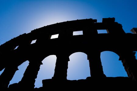 silhouette of the ancient amphitheater in pula croatia with blue skyの写真素材