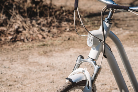 Detail view of bicycle on road - light on for safetyの写真素材