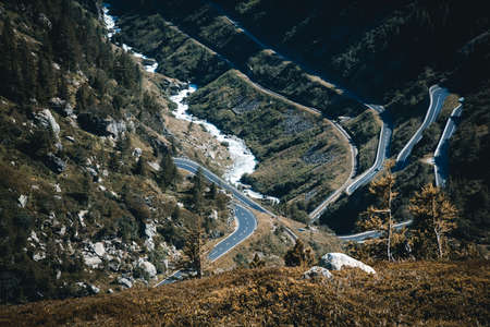 winding pass road in the Swiss Alps surrounded by mountainsの写真素材