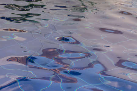 Wavy water surface in a fountain in blue tonesの写真素材