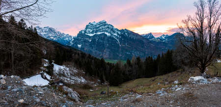 colorful sunset with mountains in swiss alpsの写真素材