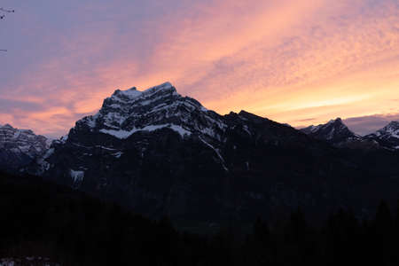 colorful sunset with mountains in swiss alpsの写真素材