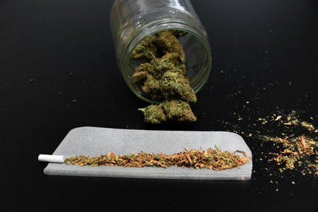 Cannabis buds in a jar and other smoking utensilsの写真素材