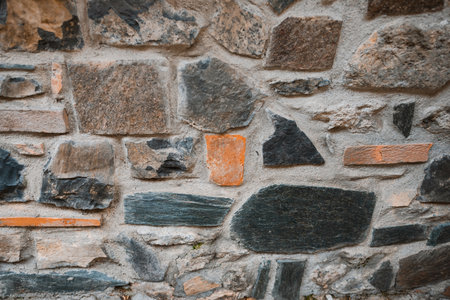 Wall structure of old building with stones, mortar and concreteの写真素材