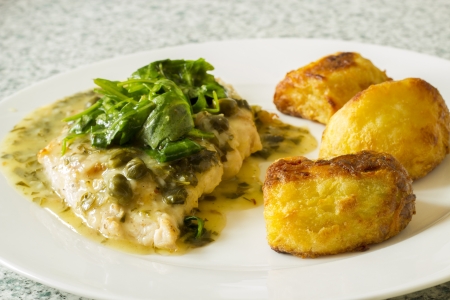 Chicken breast with sauce and potatoの写真素材