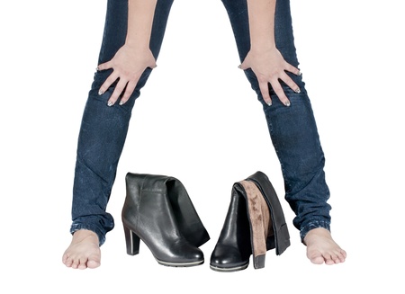 Beautiful female legs and boots isolated on whiteの写真素材