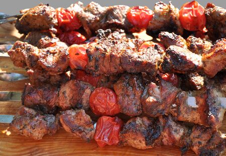 pork shashlik with tomatoes preparation on fireの写真素材