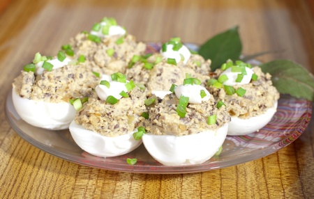 Stuffed eggs with green onions on a plateの写真素材