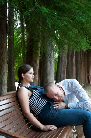 pregnant woman with husband in the parkの写真素材