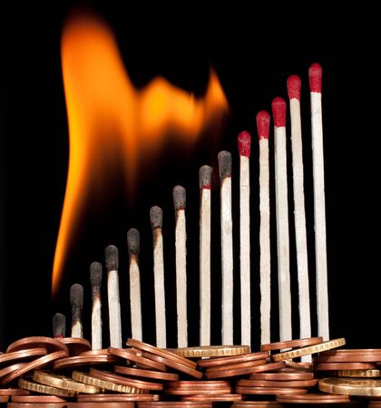graph of the burning matches against moneyの写真素材