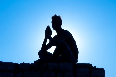 silhouette of a man who prays Godの写真素材