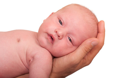 newborn laying on the hand of father