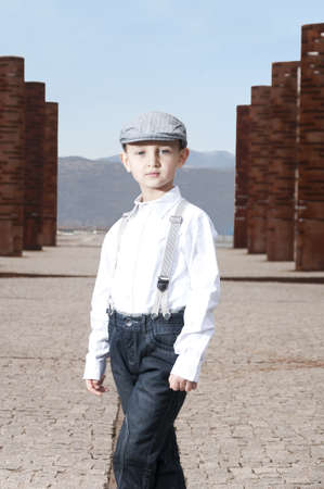 cute boy dressed in fashionable clothes outdoorsの写真素材