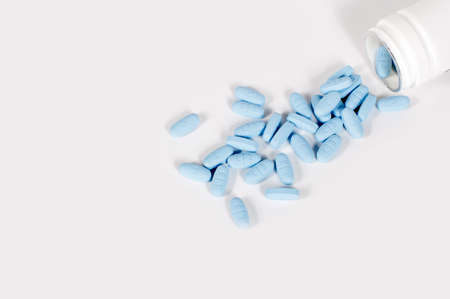 blue vitamins and a bottle on white backgroundの写真素材