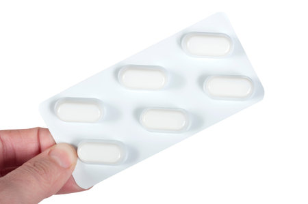 pills in female hand isolated on white