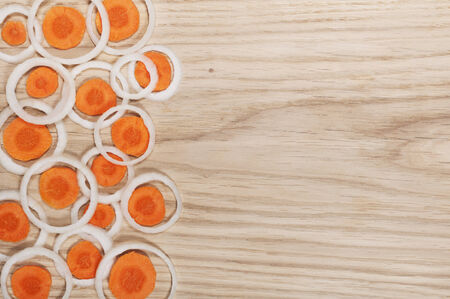 onion with carrot cut into rings on the boardの写真素材
