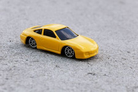 closeup yellow toy car on the roadの写真素材