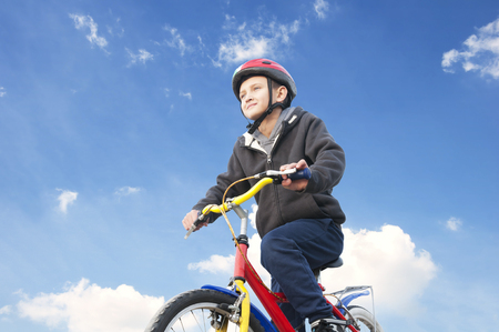 boy on the bike against the skyの写真素材