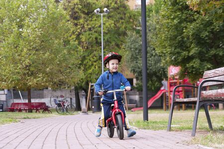 little boy riding a bike in the parkの写真素材