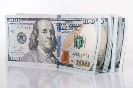 stack of hundred dollar bills on white background
