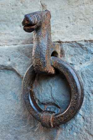 big rusty ring on the old wall in Bergamo, Italy