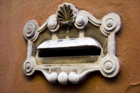 vintage marble mailbox on the wall of a house in Italyの写真素材