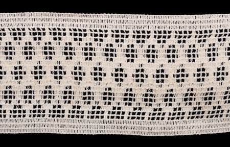 white vintage macrame lace isolated on black backgroundの写真素材