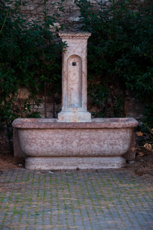 vintage fountain with drinking water in a public park in Italyの写真素材