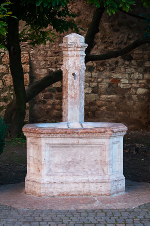vintage fountain with drinking water in a public park in Italyの写真素材
