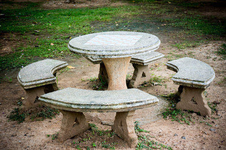 old stone table and stool in the garden.