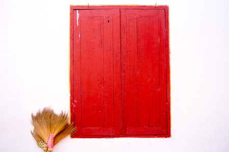 old red window and two old blooms.の写真素材