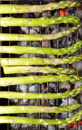 green asparagus cooking and steaming on grill plateGRILLED ASPARAGUSの写真素材