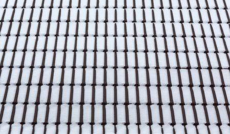 Snow on roof tiles. Winter texture, abstract backgroundの写真素材