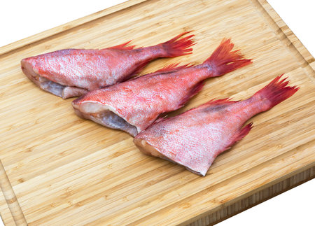 Fresh raw red fish on wooden cutting board. Raw red sea perches