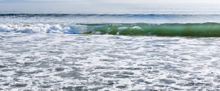 Wave of the sea on the beach with sunlight. Natural composition.の写真素材