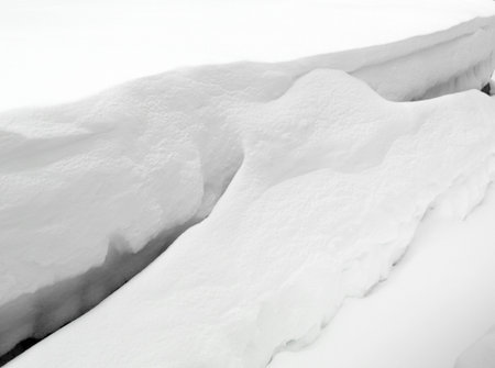 Snow drift. Deep snow drifts in the winter. Snow drift sculpted by strong winter blizzard.