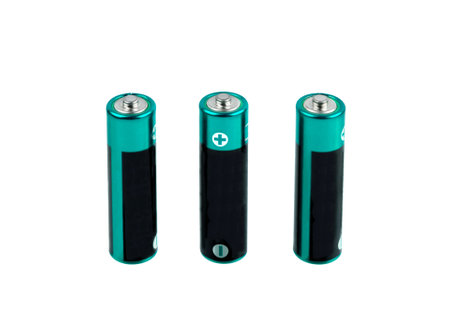 Batteries isolated on white background. Three green AA size batteries.の写真素材