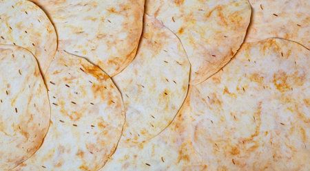 Shortbread cookies for assembly of cake. Close up. Cake layers as a background. Bakery
