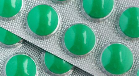 Close-up on blister of medical pills. Background of medicine pills. Pile of green tablets pill in blister packaging.の写真素材