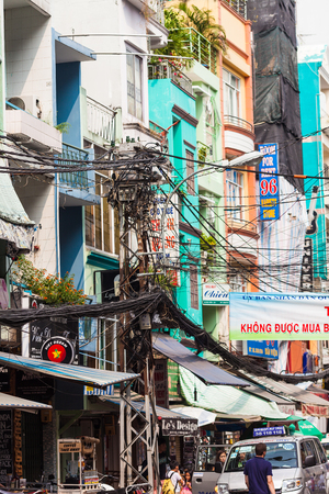 Ho Chi Minh City, Vietnam-December 9, 2013. Tangle of electrical wires on power pole at one of many streets of the city on December 9, 2013 in Ho Chi Minh City, Vietnam.のeditorial素材